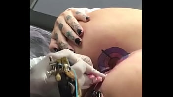 Getting a tattoo on her ass